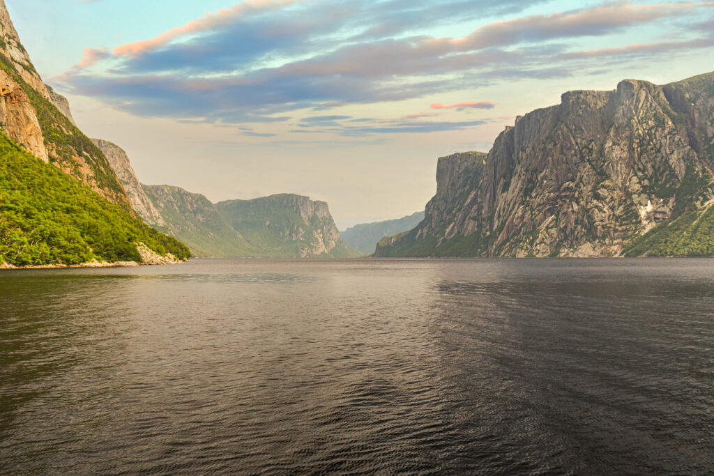 Admiring the beautiful view from the tour boat at the fjords of the Western brook pond in Gros Morne National Park, Newfoundland and Labrador