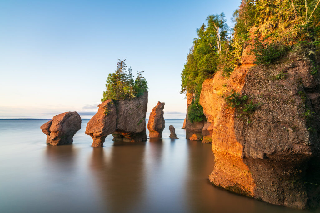 Hopewill Rock at sunrise during high tide, New Brunswick