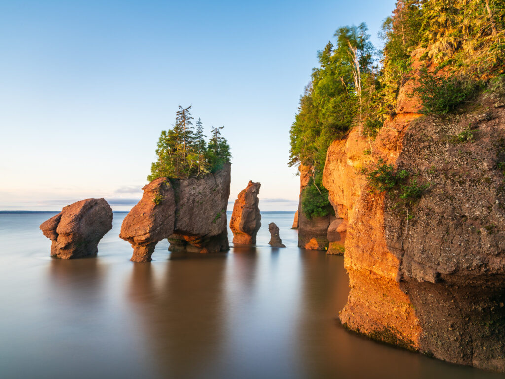 Hopewill Rock at sunrise during high tide, New Brunswick