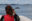 Young girl takes a photo of a Minke whale on the Bay of Fundy, New Brunswick, Canada