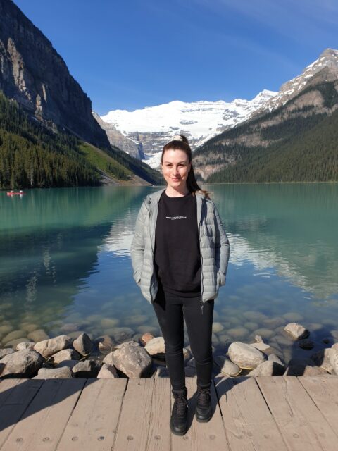 Rebecca standing in front of a lake in Canada