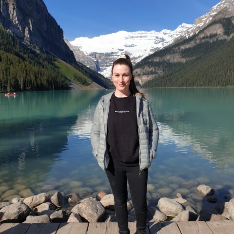 Rebecca standing in front of a lake in Canada