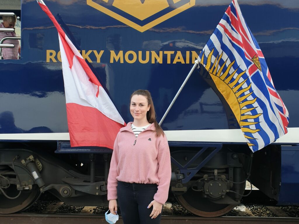 Rebecca standing in front of the Rocky Mountaineer train