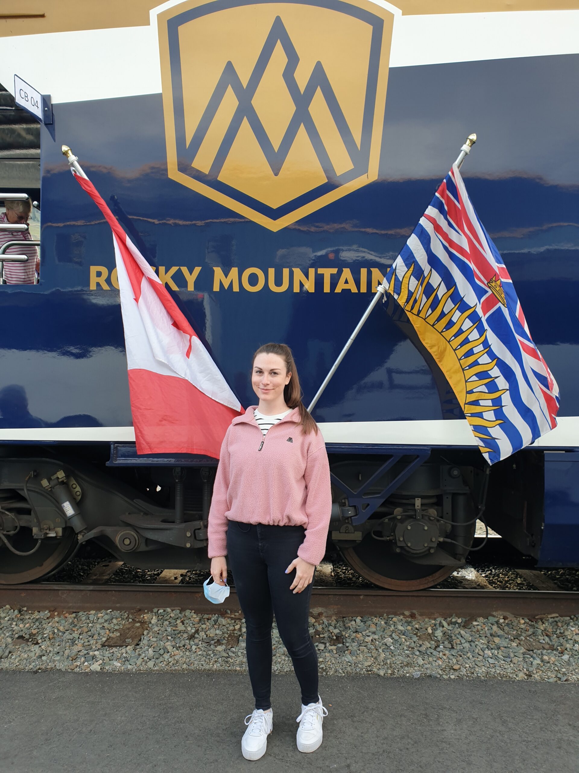 Rebecca standing in front of the Rocky Mountaineer train