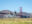 Two bicycles parked on grass in front of Golden Gate Bridge