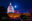 Illuminated dome of the white United States capital building at night with full moon in background