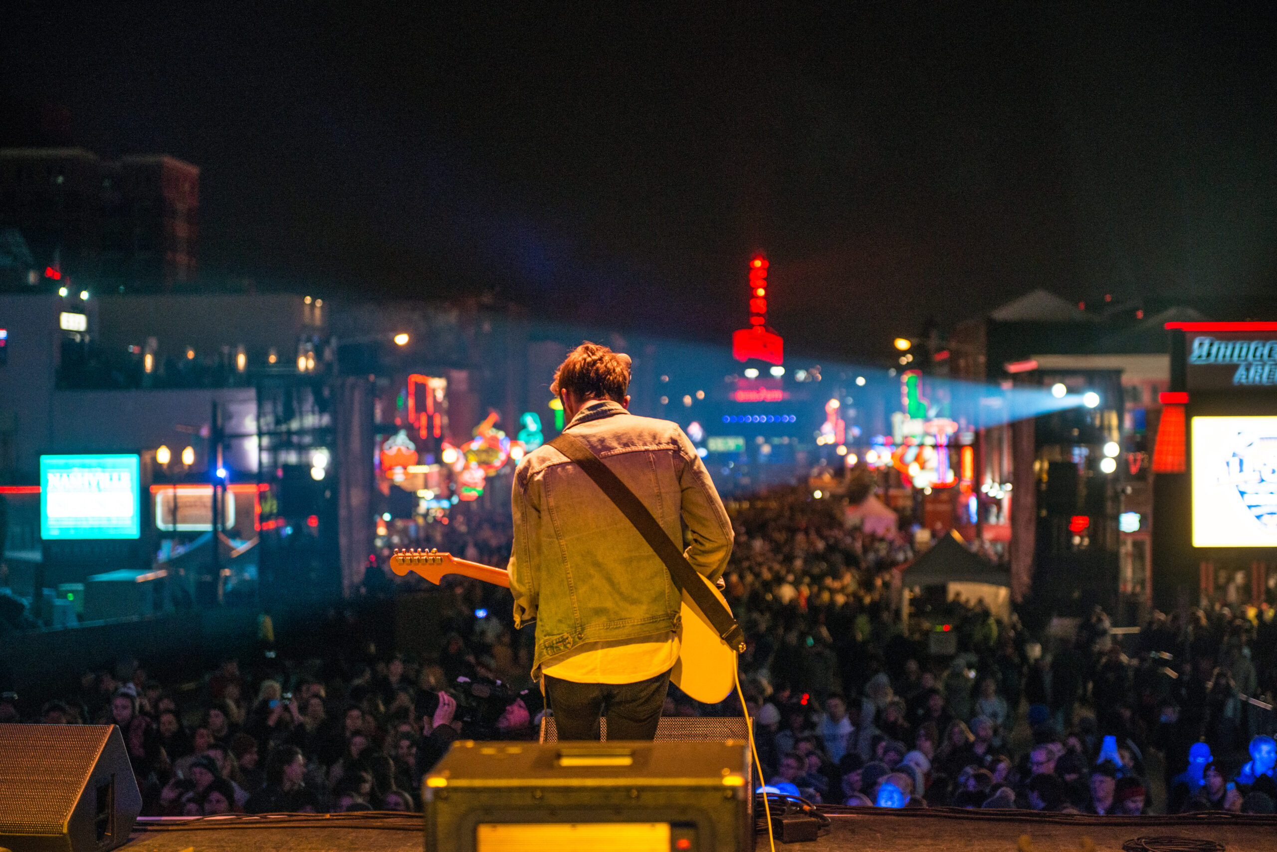 Musician playing guitar to a crowd in Nashville, Tennessee