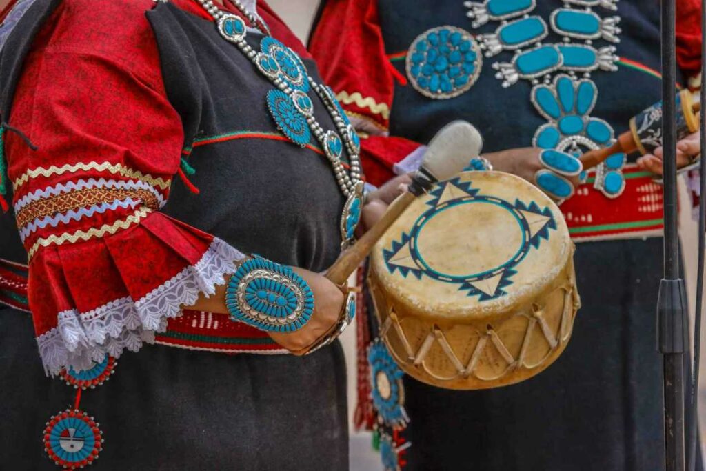 Zuni Indian plays drum in ceremony