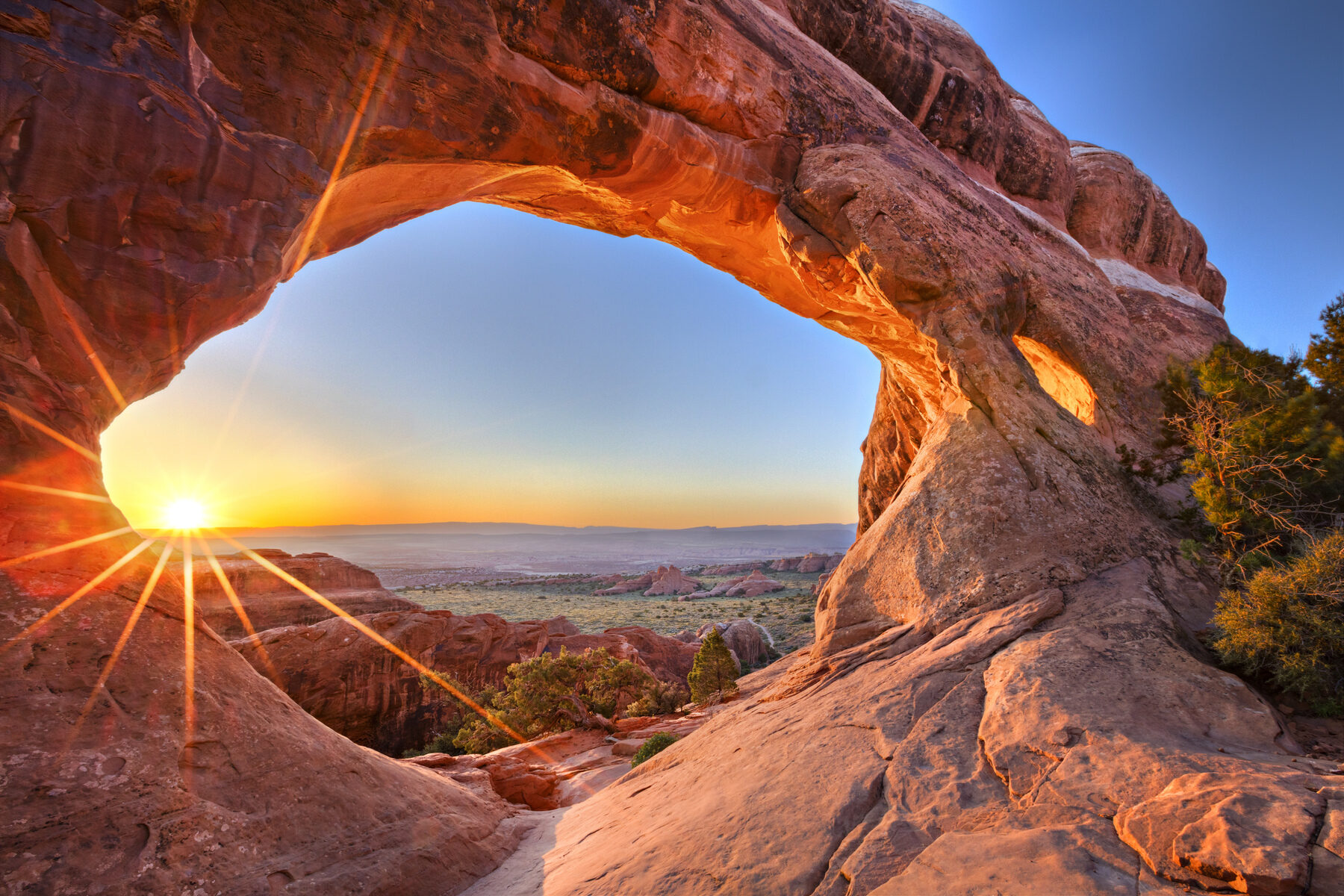 Sunrise at Partition Arch, in Arches National Park.